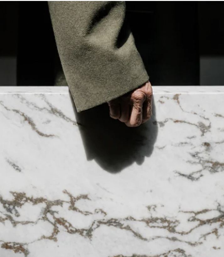 Hand inspecting a marble surface