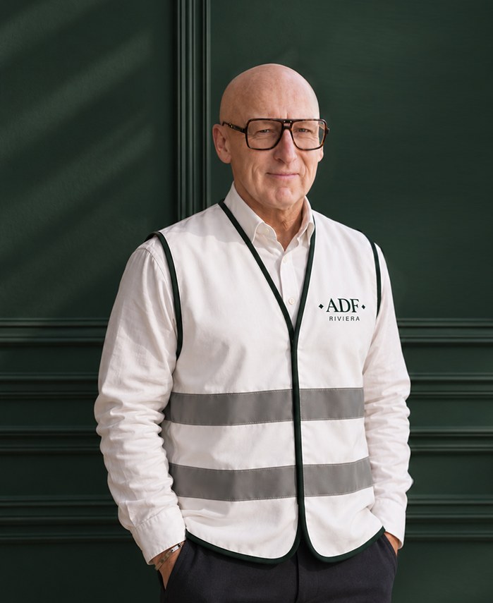 Man in a cream ADF Riviera safety vest in front of a green paneled wall