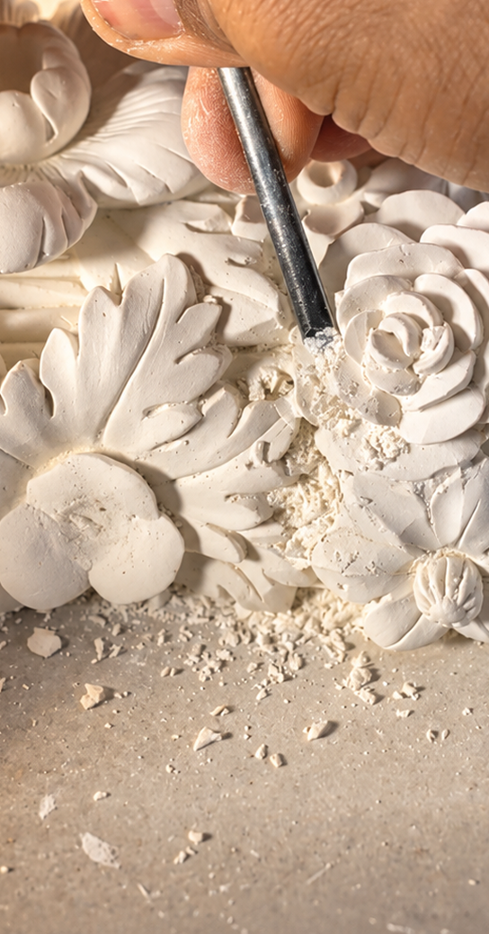 Sculptor carving plaster ornament